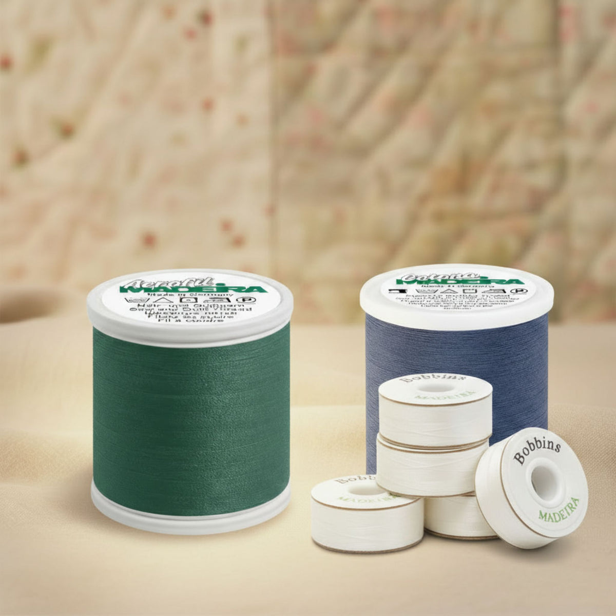 Madeira Aerofil polyester thread spools with prewound bobbins displayed on a quilt background
